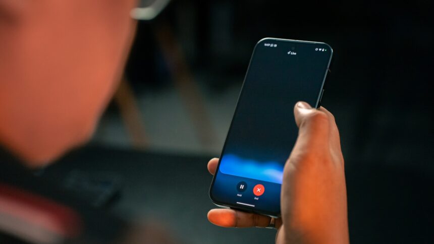 A person holding a cell phone in their hand